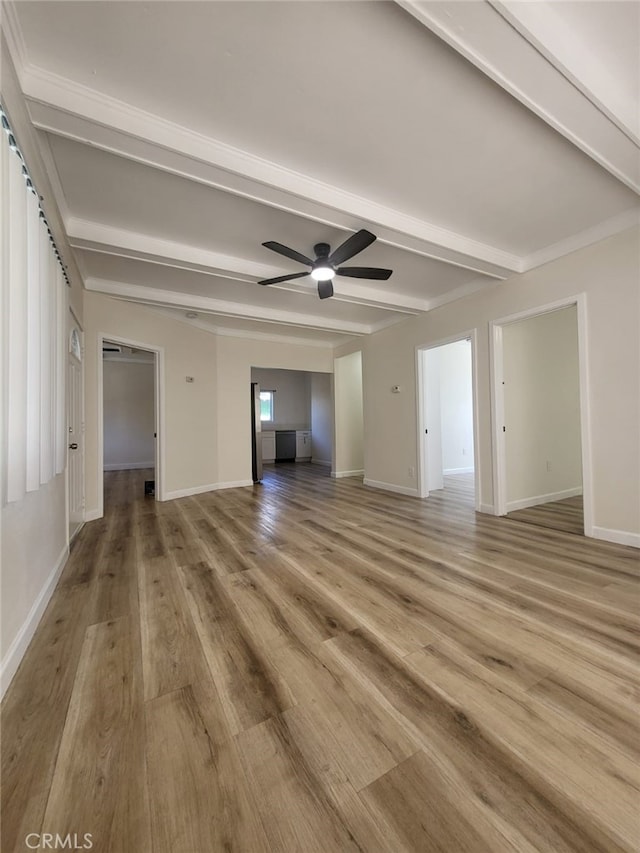 spare room featuring ceiling fan, hardwood / wood-style floors, and beamed ceiling