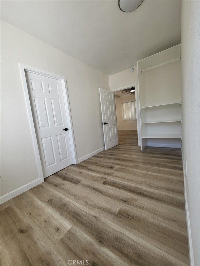 unfurnished bedroom featuring light hardwood / wood-style flooring and a closet