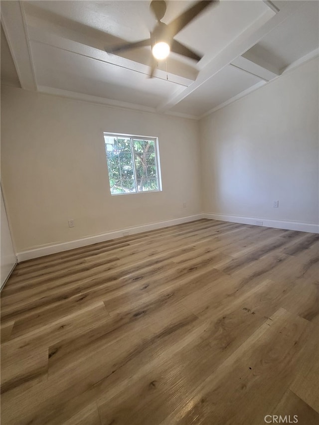 spare room with beamed ceiling and hardwood / wood-style floors