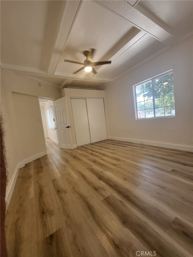 unfurnished bedroom with ceiling fan, a closet, and light hardwood / wood-style flooring