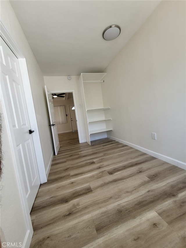 unfurnished bedroom featuring light wood-type flooring and a closet