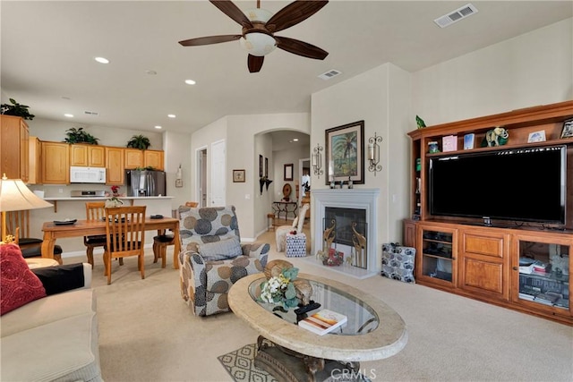 carpeted living room featuring ceiling fan