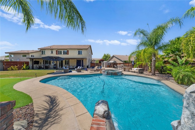 view of pool with an outdoor living space, an in ground hot tub, a lawn, and a patio