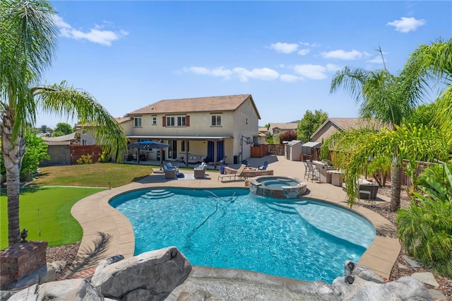 view of pool with an in ground hot tub, a lawn, an outdoor hangout area, and a patio