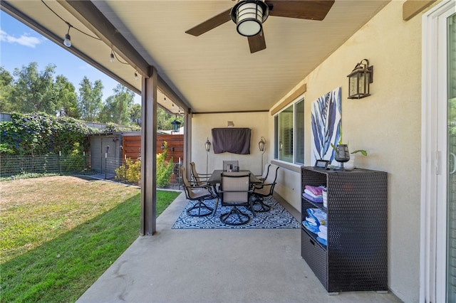 view of patio / terrace with ceiling fan and a shed