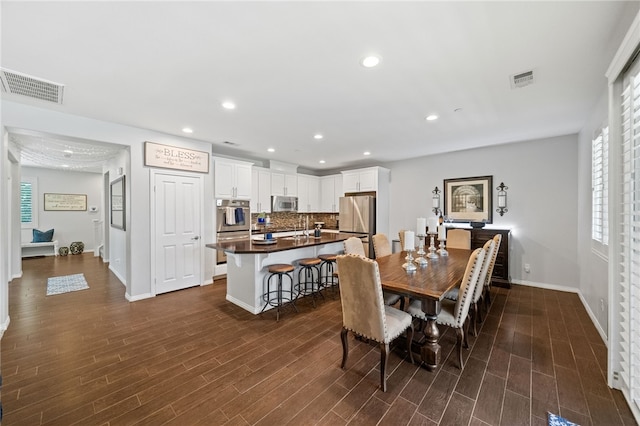 dining room with dark hardwood / wood-style floors