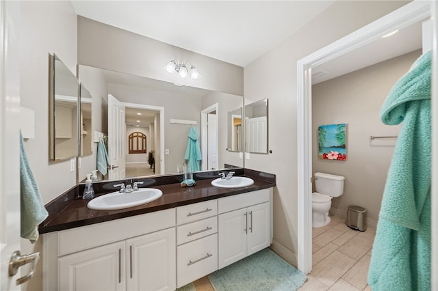 bathroom featuring tile patterned floors, toilet, and vanity