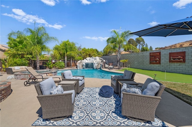 view of swimming pool featuring pool water feature, a patio area, and a jacuzzi