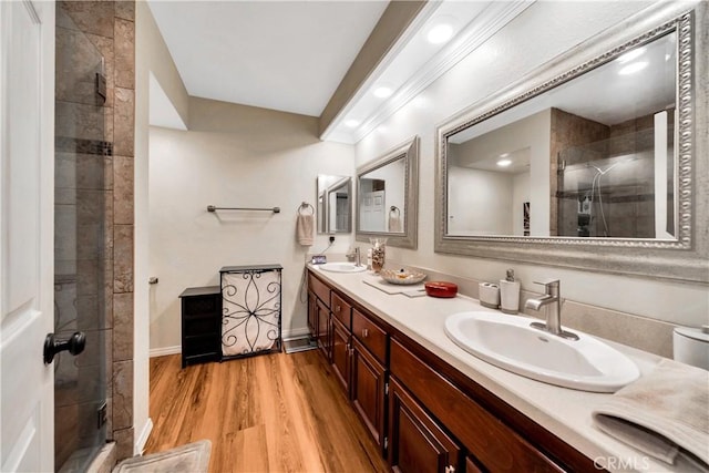 bathroom featuring vanity, an enclosed shower, and wood-type flooring