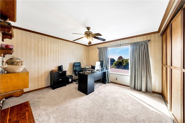 office space featuring ceiling fan, crown molding, and light carpet