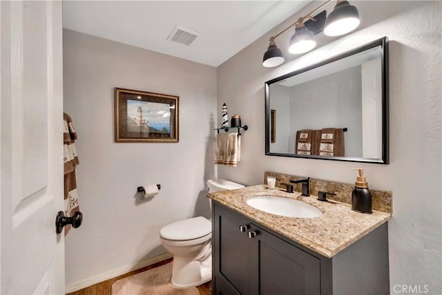 bathroom with toilet and vanity