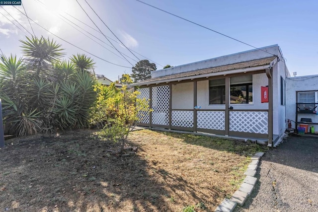 view of property exterior featuring a yard and a porch