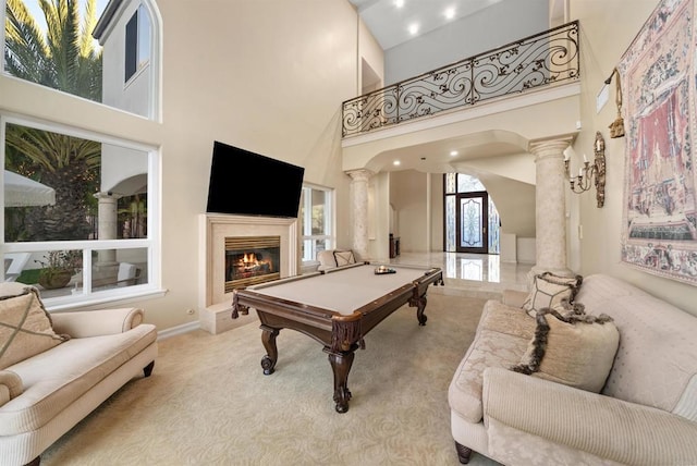 rec room featuring light carpet, ornate columns, a high ceiling, and billiards