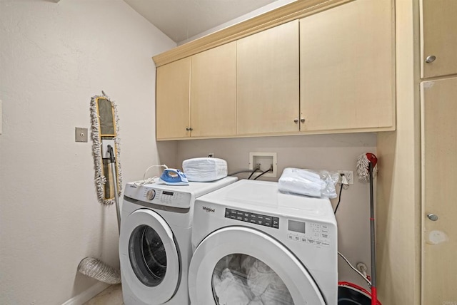 laundry area featuring cabinets and washer and clothes dryer