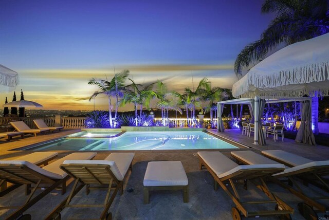 pool at dusk with a patio