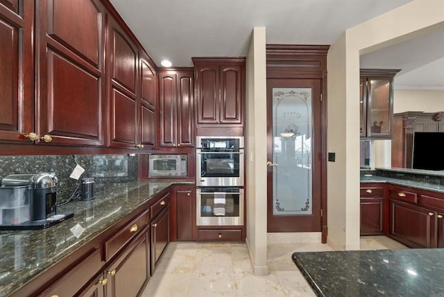 kitchen with stainless steel appliances, ornamental molding, tasteful backsplash, and dark stone counters