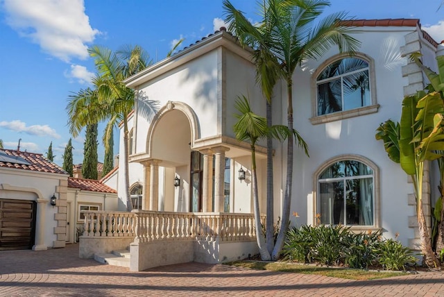 mediterranean / spanish home with covered porch