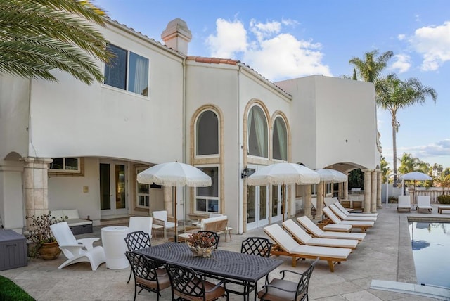 rear view of property featuring french doors and a patio