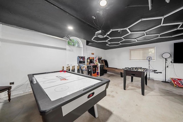 recreation room with concrete flooring