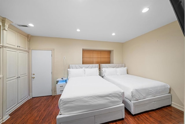 bedroom with dark hardwood / wood-style floors