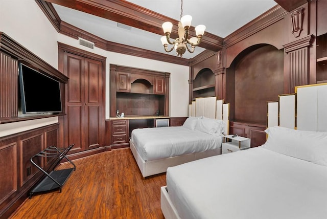 bedroom featuring dark wood-type flooring, crown molding, and a chandelier