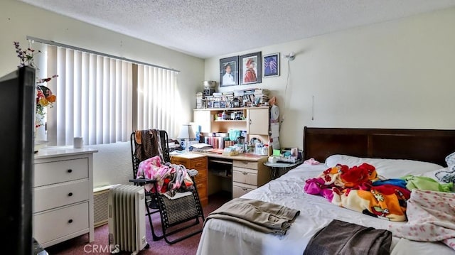 bedroom featuring radiator heating unit, a textured ceiling, and dark colored carpet