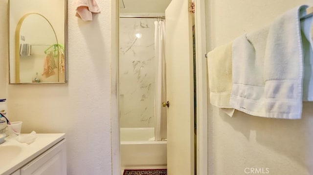 bathroom featuring washtub / shower combination and vanity