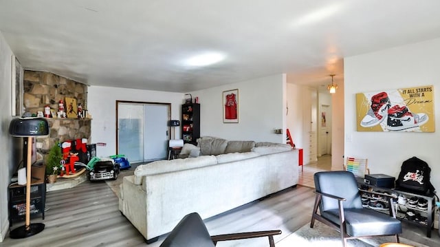 living room featuring an inviting chandelier and wood-type flooring