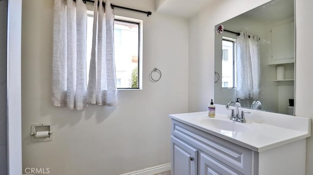 bathroom with a healthy amount of sunlight and vanity