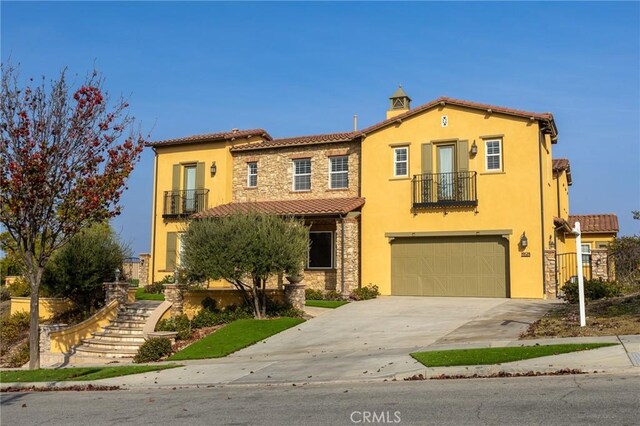 mediterranean / spanish-style home with a garage and a balcony