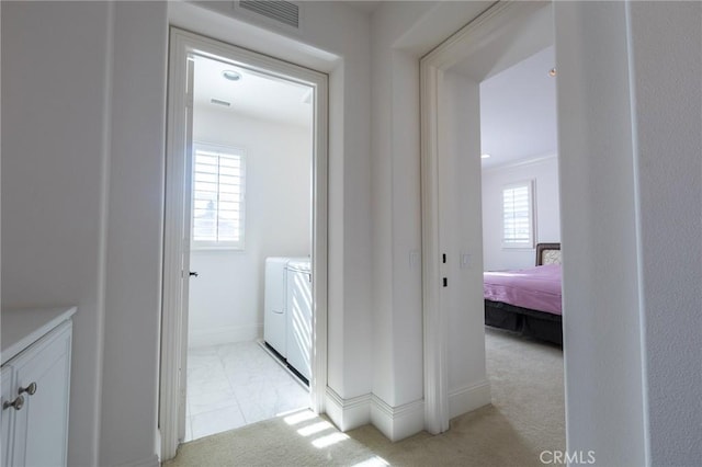 bathroom with washing machine and clothes dryer