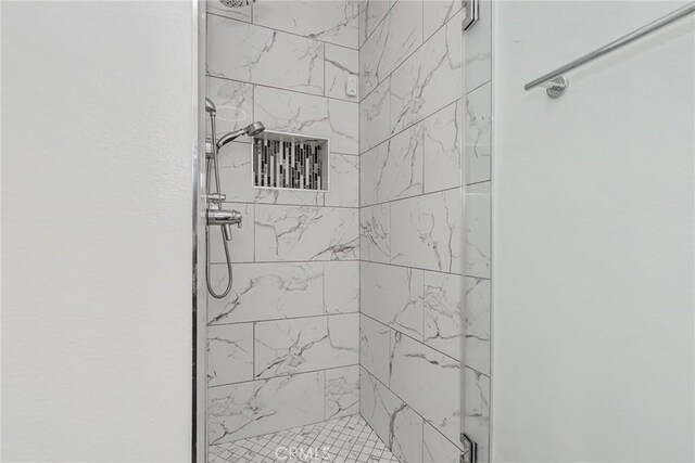 bathroom with a tile shower