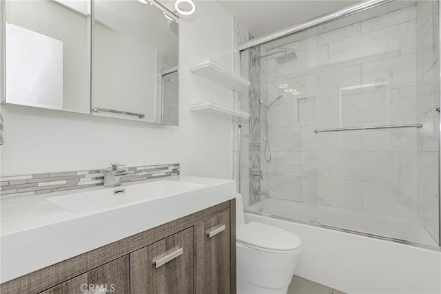 full bathroom featuring toilet, enclosed tub / shower combo, backsplash, and vanity