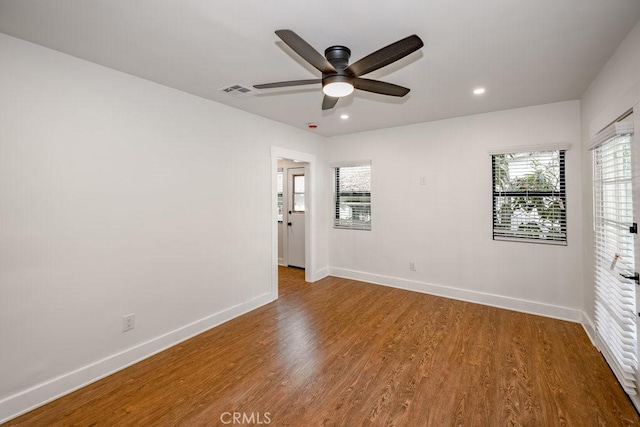 unfurnished room with ceiling fan and hardwood / wood-style flooring