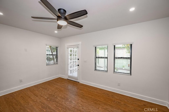 unfurnished room with ceiling fan and hardwood / wood-style flooring