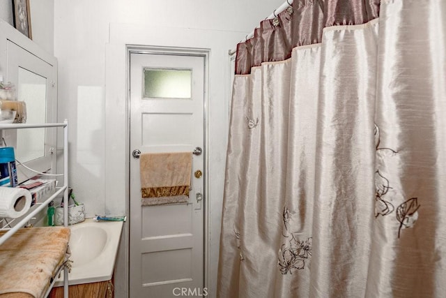 bathroom featuring vanity and curtained shower