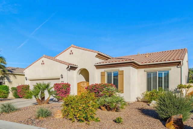 mediterranean / spanish-style house featuring a garage