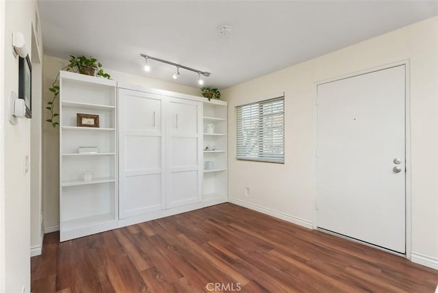 unfurnished bedroom featuring dark wood-type flooring