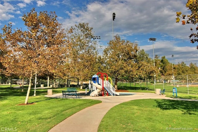 surrounding community with a playground and a yard