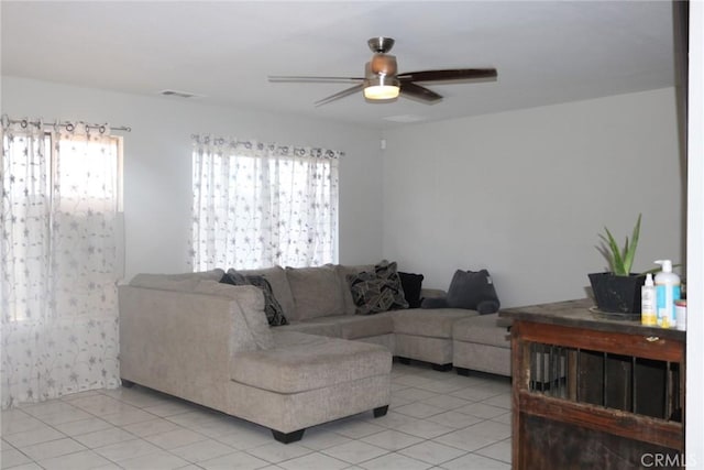 tiled living room featuring ceiling fan