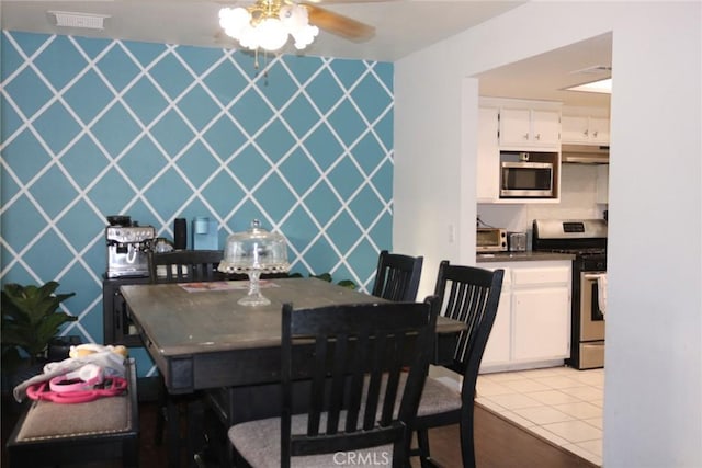 tiled dining area featuring ceiling fan