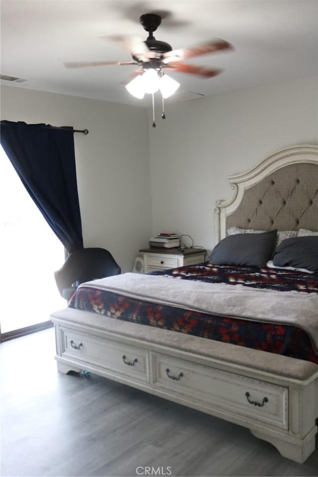 bedroom with ceiling fan and hardwood / wood-style floors