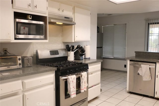 kitchen with white cabinetry, appliances with stainless steel finishes, and light tile patterned floors