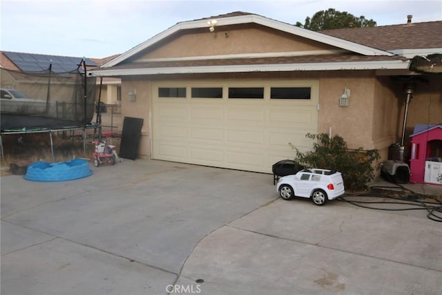 exterior space featuring a trampoline and a garage