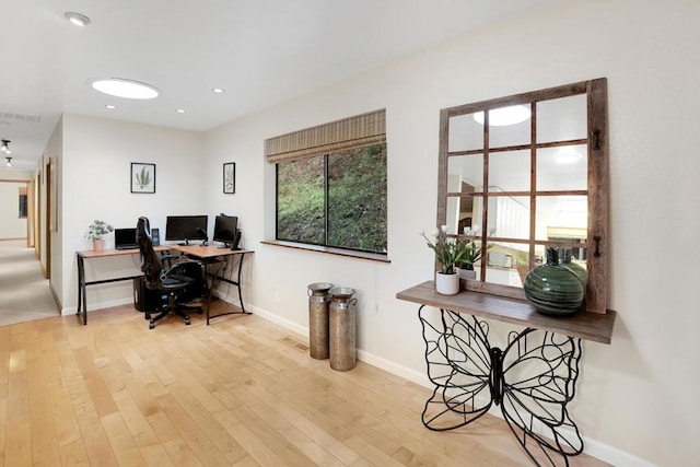 office with light hardwood / wood-style flooring