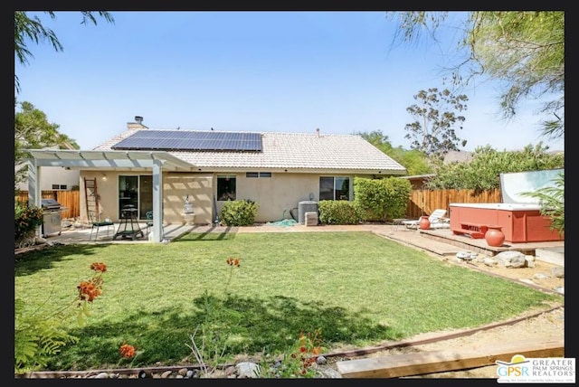 back of property featuring a patio area, central AC, a hot tub, and a yard