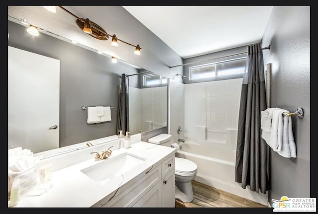 full bathroom featuring hardwood / wood-style flooring, toilet, vanity, and shower / tub combo with curtain