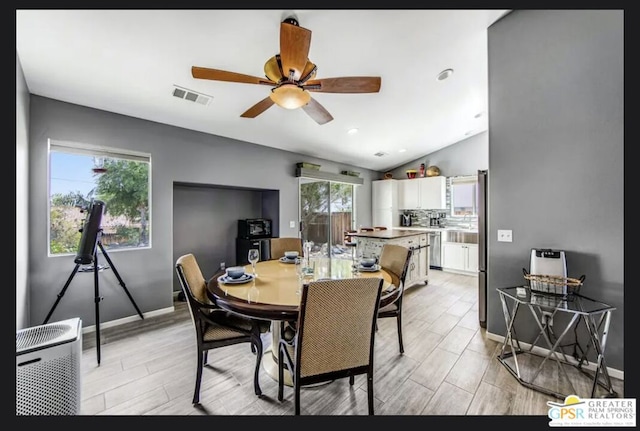 dining area featuring ceiling fan, vaulted ceiling, and a wealth of natural light