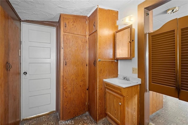 bathroom with a textured ceiling and vanity