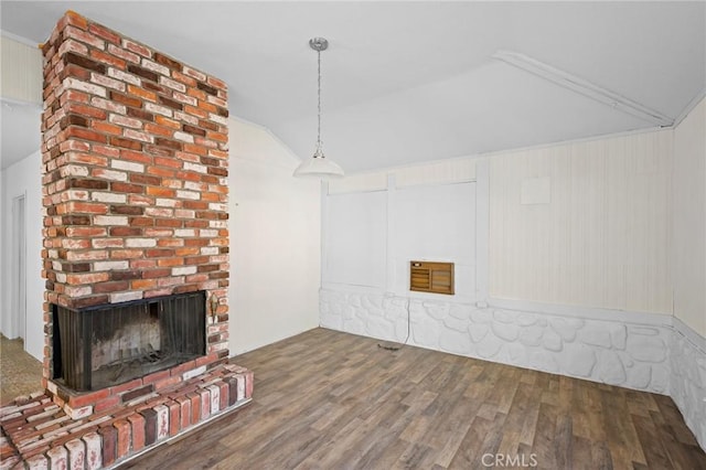 unfurnished living room featuring lofted ceiling, a brick fireplace, and hardwood / wood-style flooring